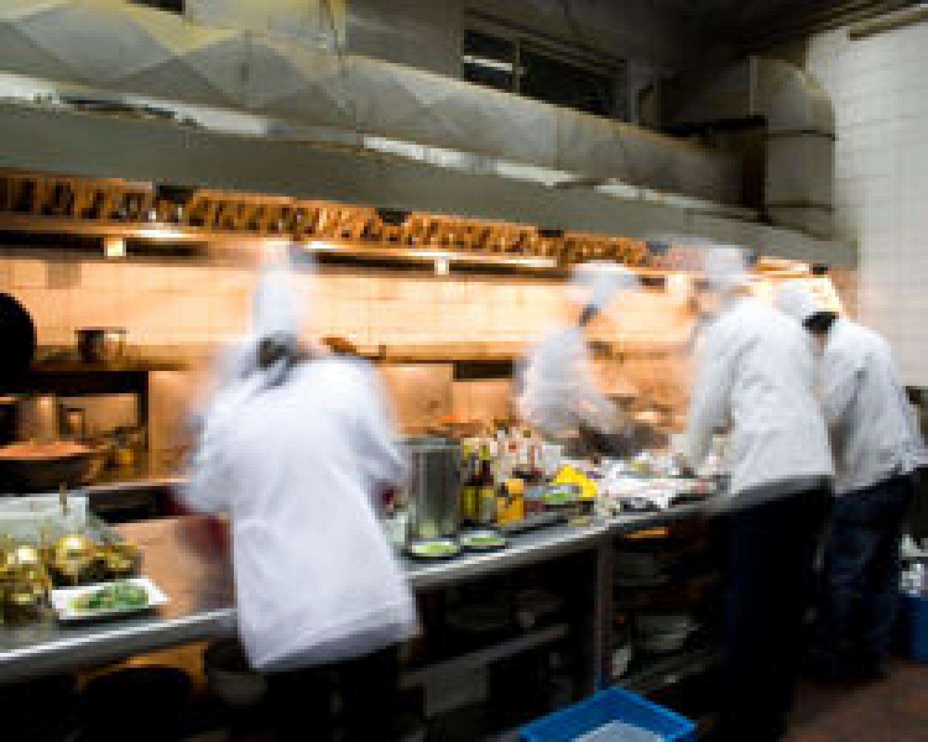 picture of chefs, busy in the kitchen