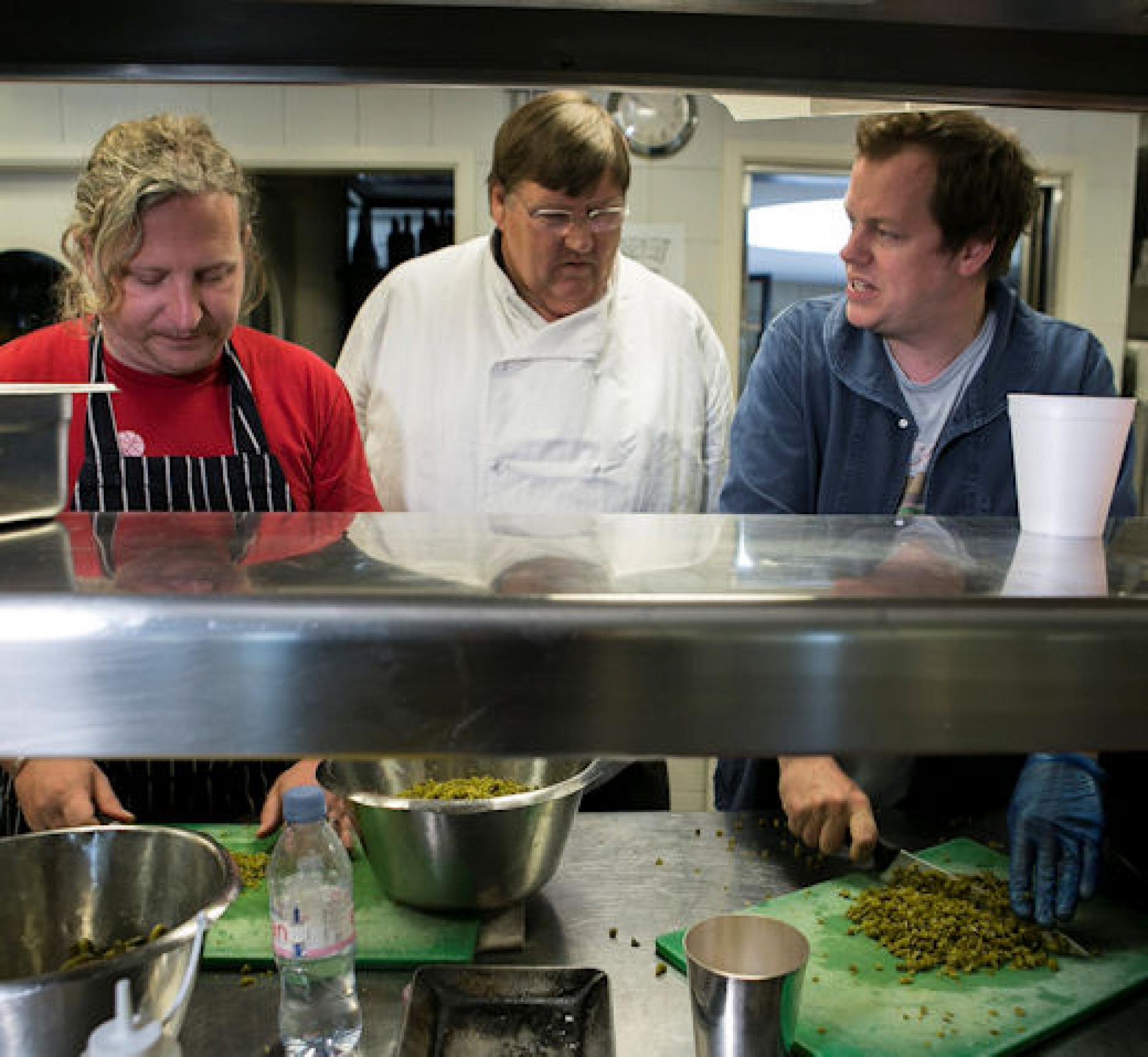 Joe Warwick and Charles Campion cooking for guests.